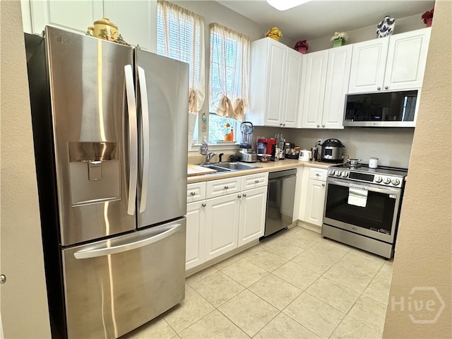 1312 Whitemarsh Way, Savannah, GA 31410 - kitchen featuring stainless steel appliances, light tile patterned floors, white cabinets, and light countertops