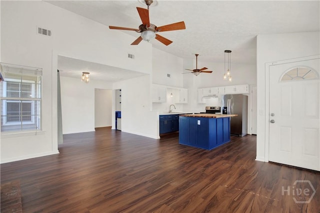 106 Dry Dock Ct, Savannah, GA 31410 - kitchen with appliances with stainless steel finishes, blue cabinets, open floor plan, ceiling fan, and white cabinetry