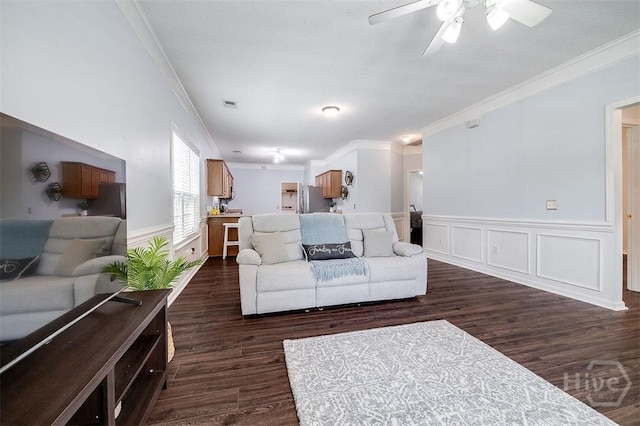 86 Fellwood Dr, Rincon, GA 31326 - living area with crown molding, a ceiling fan, dark wood finished floors, and a wainscoted wall
