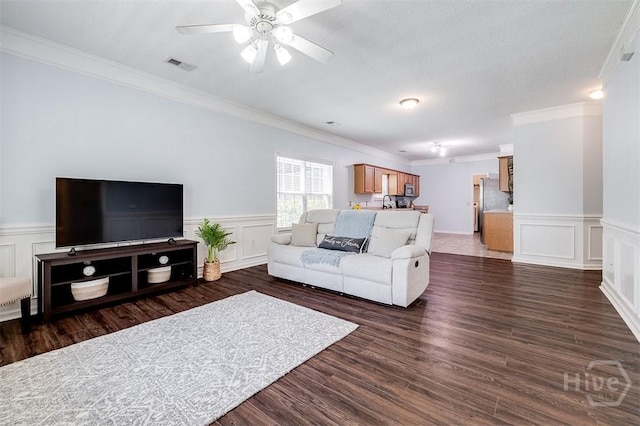 86 Fellwood Dr, Rincon, GA 31326 - living area with ornamental molding, ceiling fan, dark wood-type flooring, a decorative wall, and a wainscoted wall
