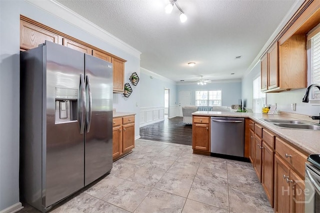86 Fellwood Dr, Rincon, GA 31326 - kitchen featuring appliances with stainless steel finishes, crown molding, light countertops, open floor plan, and brown cabinets
