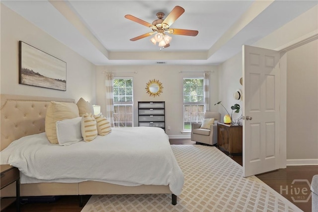 22 Carriage Way, Midway, GA 31320 - bedroom featuring a tray ceiling, dark wood finished floors, and ceiling fan