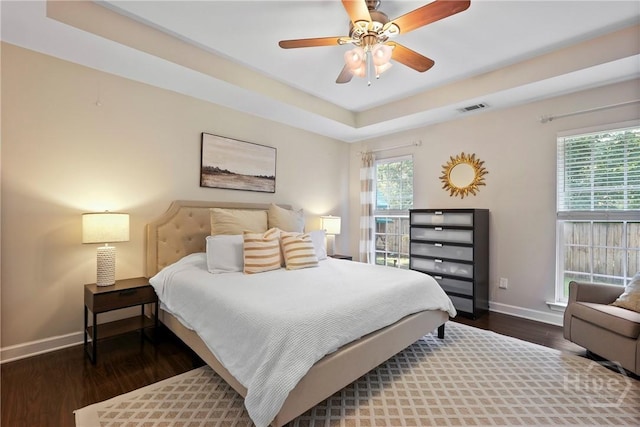22 Carriage Way, Midway, GA 31320 - bedroom with wood finished floors, a tray ceiling, and a ceiling fan