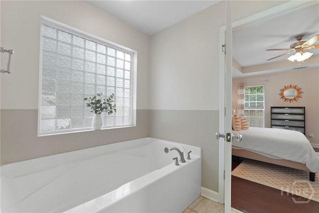 22 Carriage Way, Midway, GA 31320 - full bathroom with a garden tub, ensuite bath, a ceiling fan, and tile patterned flooring