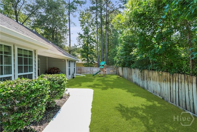 22 Carriage Way, Midway, GA 31320 - fenced backyard featuring a playground