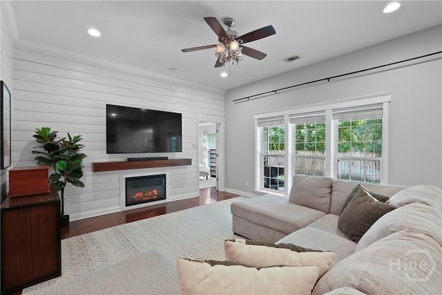 22 Carriage Way, Midway, GA 31320 - living room with ceiling fan, recessed lighting, a glass covered fireplace, wood finished floors, and wood walls