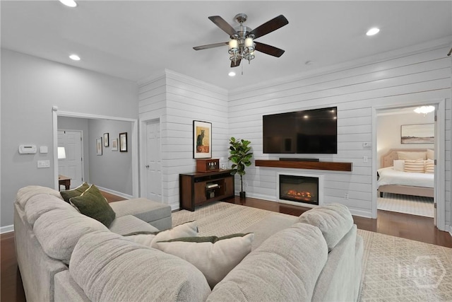 22 Carriage Way, Midway, GA 31320 - living room featuring a ceiling fan, wood finished floors, recessed lighting, wooden walls, and a glass covered fireplace
