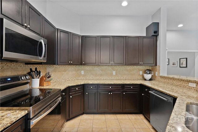 22 Carriage Way, Midway, GA 31320 - kitchen with stainless steel appliances, tasteful backsplash, light stone counters, light tile patterned flooring, and recessed lighting