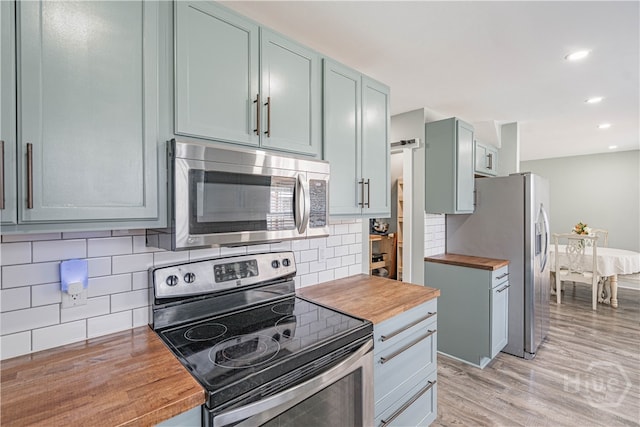 100 Live Oak Cir, Rincon, GA 31326 - kitchen featuring stainless steel appliances, butcher block counters, tasteful backsplash, light wood-style floors, and recessed lighting