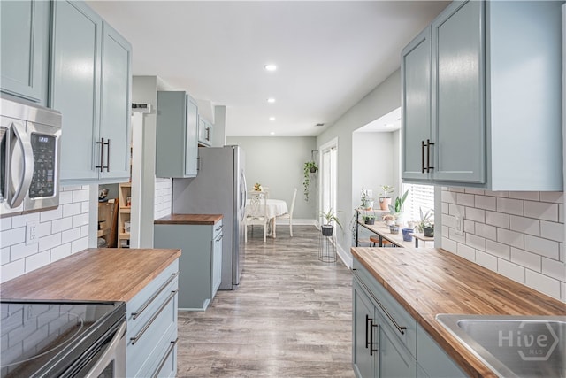 100 Live Oak Cir, Rincon, GA 31326 - kitchen featuring butcher block countertops, appliances with stainless steel finishes, backsplash, and recessed lighting