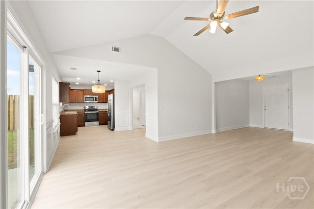 164 Whirlwind Way, Guyton, GA 31312 - unfurnished living room featuring light wood finished floors, ceiling fan, lofted ceiling, and recessed lighting