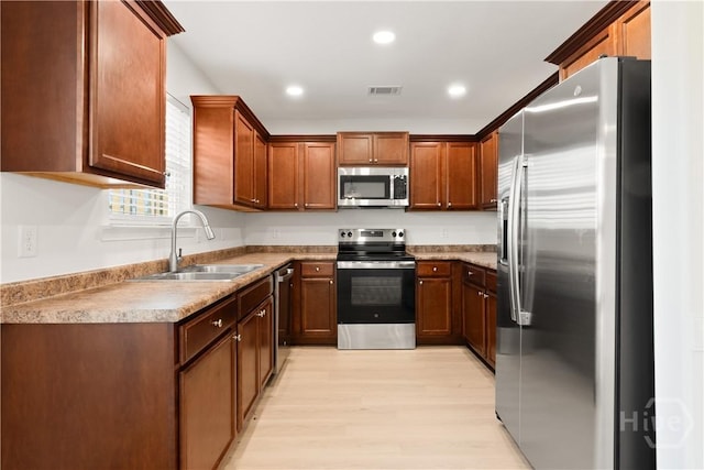 164 Whirlwind Way, Guyton, GA 31312 - kitchen featuring appliances with stainless steel finishes, light wood finished floors, recessed lighting, light countertops, and brown cabinets