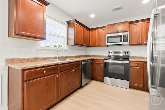 164 Whirlwind Way, Guyton, GA 31312 - kitchen featuring stainless steel appliances, light wood-style flooring, brown cabinetry, light countertops, and recessed lighting