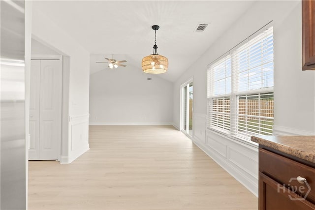 164 Whirlwind Way, Guyton, GA 31312 - unfurnished dining area with light wood-style flooring, plenty of natural light, ceiling fan, lofted ceiling, and wainscoting