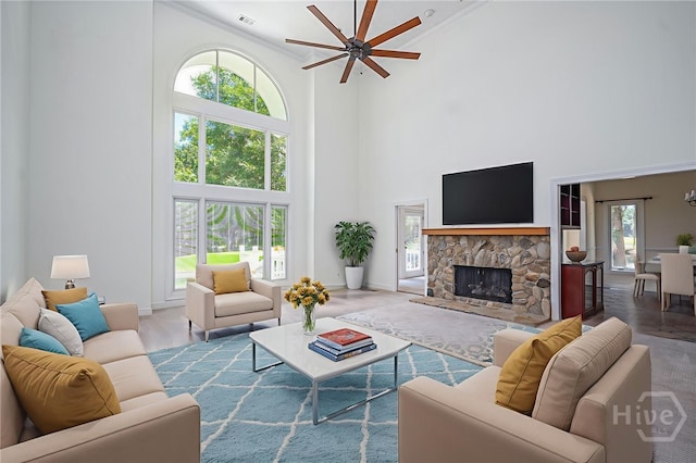 1 Hobcaw Ln, Savannah, GA 31411 - living area with a towering ceiling, a ceiling fan, ornamental molding, a fireplace, and wood finished floors