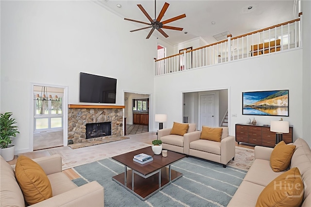 1 Hobcaw Ln, Savannah, GA 31411 - living room featuring a towering ceiling, ceiling fan, stairway, a fireplace, and crown molding