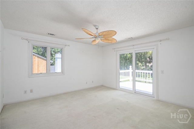 1 Hobcaw Ln, Savannah, GA 31411 - carpeted empty room featuring healthy amount of natural light, a textured ceiling, and a ceiling fan