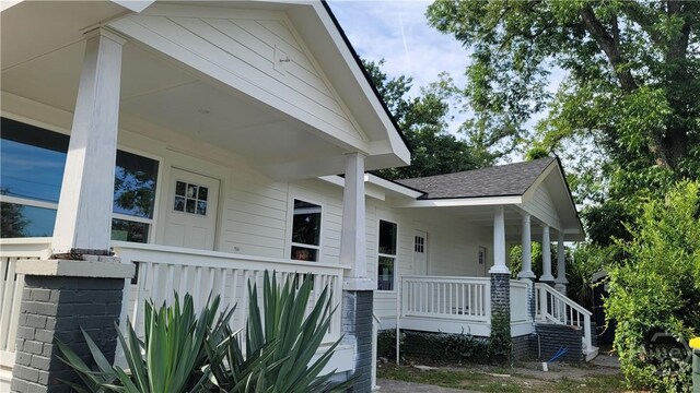 8-10 Mastick St, Savannah, GA 31404 - property entrance with covered porch and a shingled roof