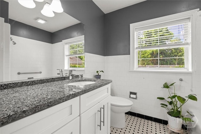 540 E 60th St, Savannah, GA 31405 - full bath with vanity, tile walls, a wainscoted wall, and tile patterned floors