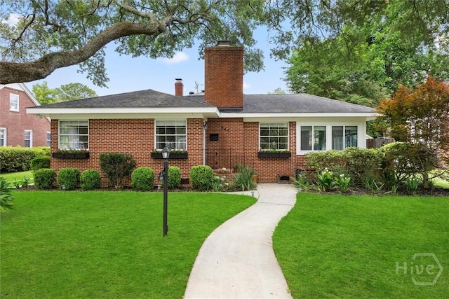 540 E 60th St, Savannah, GA 31405 - view of front facade with a chimney, a front lawn, and brick siding