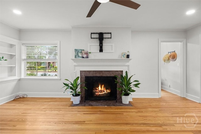 540 E 60th St, Savannah, GA 31405 - living area with a fireplace with flush hearth, ceiling fan, wood finished floors, ornamental molding, and recessed lighting