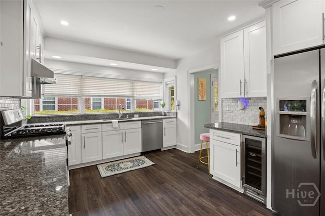 540 E 60th St, Savannah, GA 31405 - kitchen featuring stainless steel appliances, wine cooler, range hood, tasteful backsplash, and dark stone counters