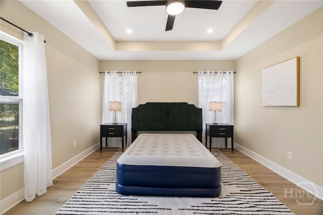 402 E 57th St, Savannah, GA 31405 - bedroom featuring a raised ceiling, light wood finished floors, ceiling fan, and recessed lighting