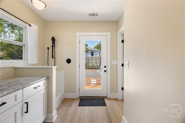 402 E 57th St, Savannah, GA 31405 - doorway with light wood finished floors and baseboards