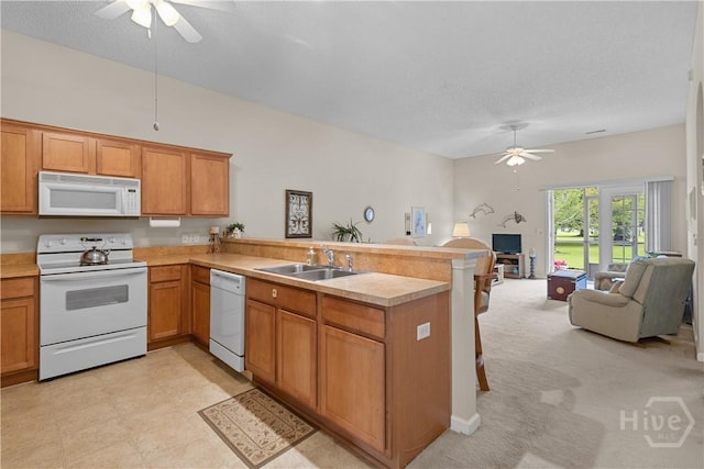 19 Travertine Cir, Savannah, GA 31419 - kitchen with white appliances, a ceiling fan, a peninsula, open floor plan, and light countertops