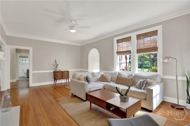 1406 E 50th St, Savannah, GA 31404 - living area with ceiling fan, arched walkways, ornamental molding, and light wood-style flooring