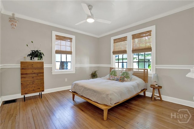 1406 E 50th St, Savannah, GA 31404 - bedroom featuring multiple windows, hardwood / wood-style floors, ornamental molding, and a ceiling fan