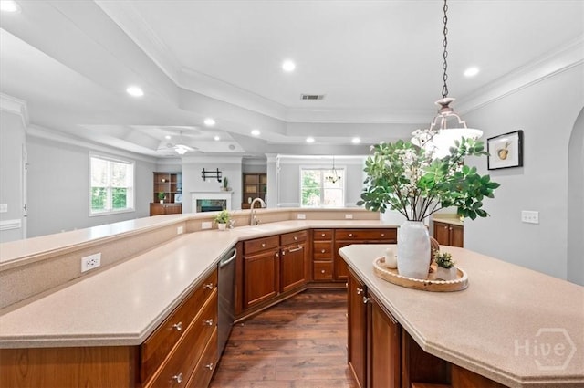 2604 River Oaks Dr Unit 2604, Richmond Hill, GA 31324 - kitchen with a tray ceiling, stainless steel dishwasher, a spacious island, light countertops, and brown cabinetry