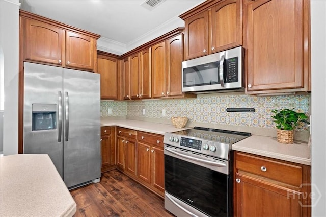 2604 River Oaks Dr Unit 2604, Richmond Hill, GA 31324 - kitchen with appliances with stainless steel finishes, dark wood-type flooring, light countertops, and crown molding