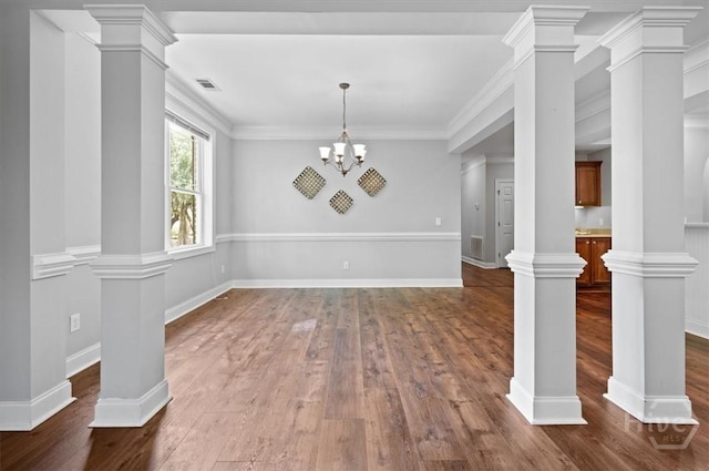 2604 River Oaks Dr Unit 2604, Richmond Hill, GA 31324 - unfurnished dining area featuring dark wood-style flooring, ornate columns, crown molding, and a chandelier