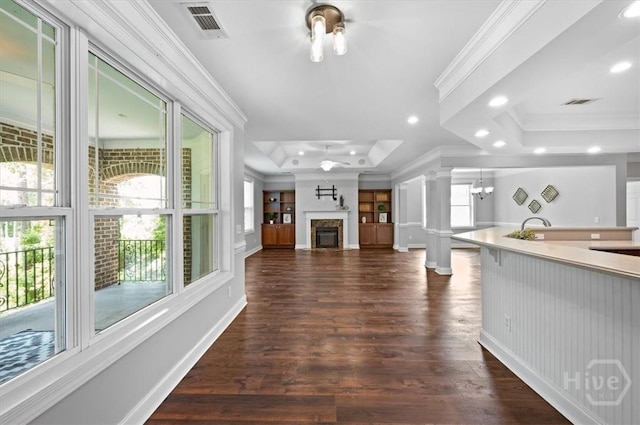 2604 River Oaks Dr Unit 2604, Richmond Hill, GA 31324 - unfurnished living room with a tray ceiling, ornamental molding, a glass covered fireplace, dark wood-style floors, and recessed lighting