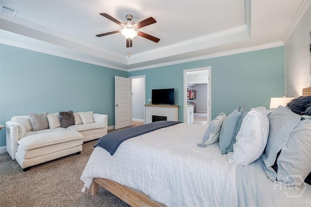 1652 Belle Island Rd, Richmond Hill, GA 31324 - bedroom with a tray ceiling, carpet, crown molding, a walk in closet, and ceiling fan