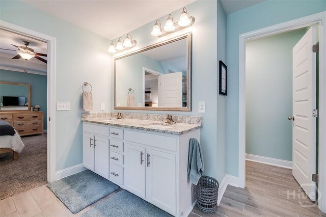 1652 Belle Island Rd, Richmond Hill, GA 31324 - ensuite bathroom with double vanity, wood finished floors, and a ceiling fan