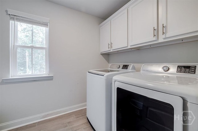 1652 Belle Island Rd, Richmond Hill, GA 31324 - laundry room featuring washer and dryer, light wood-type flooring, and cabinet space
