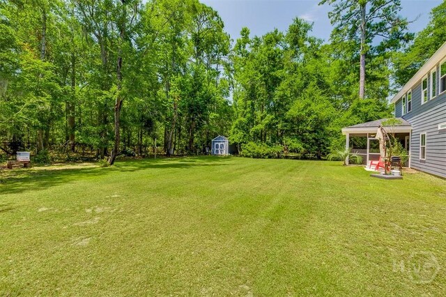 1652 Belle Island Rd, Richmond Hill, GA 31324 - view of green lawn featuring a storage unit and a patio