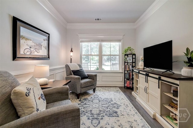 1652 Belle Island Rd, Richmond Hill, GA 31324 - living area with ornamental molding, dark wood finished floors, a wainscoted wall, and a decorative wall