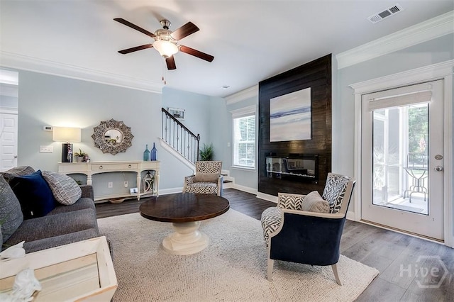 1652 Belle Island Rd, Richmond Hill, GA 31324 - living room with a fireplace, wood finished floors, stairs, ornamental molding, and ceiling fan