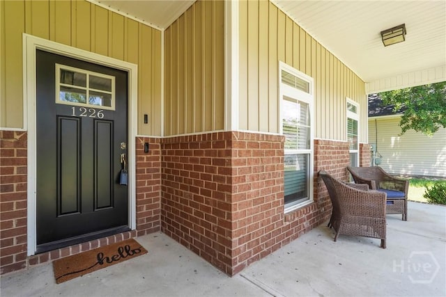 1226 Peacock Trl, Hinesville, GA 31313 - entrance to property with a porch, brick siding, and board and batten siding
