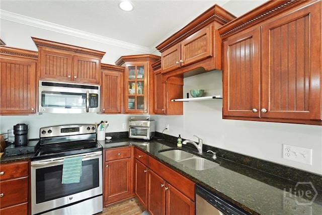 1226 Peacock Trl, Hinesville, GA 31313 - kitchen with stainless steel appliances, ornamental molding, dark stone countertops, brown cabinetry, and open shelves