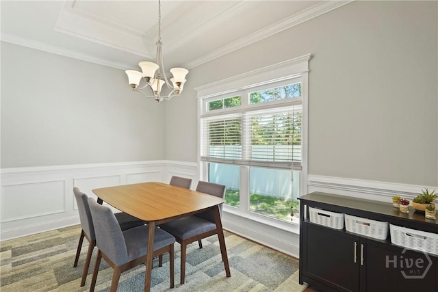 1226 Peacock Trl, Hinesville, GA 31313 - dining space with a chandelier, crown molding, a wainscoted wall, a raised ceiling, and a decorative wall