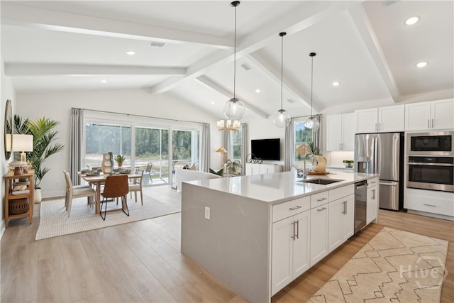125 Mage St, Savannah, GA 31302 - kitchen featuring stainless steel appliances, light wood-type flooring, light countertops, white cabinetry, and pendant lighting