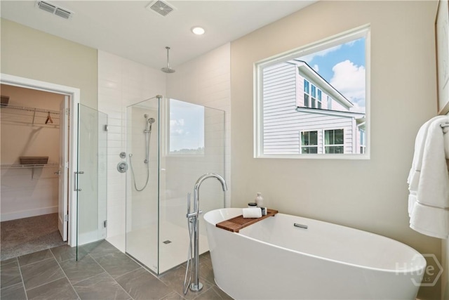 125 Mage St, Savannah, GA 31302 - full bath with a shower stall, a spacious closet, and healthy amount of natural light