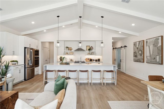 117 Mage St, Savannah, GA 31302 - living room with recessed lighting, a barn door, and light wood finished floors