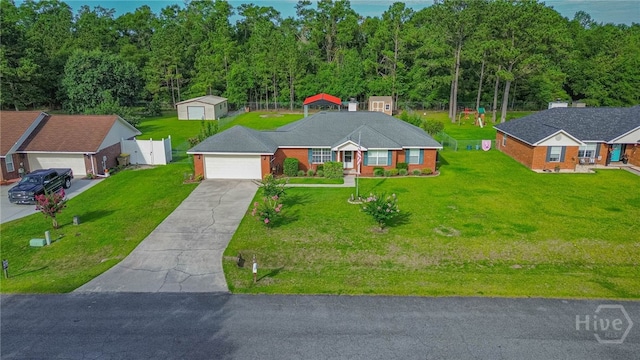 124 Jennifer Cir, Rincon, GA 31326 - view of front of property with concrete driveway, a storage unit, and an attached garage