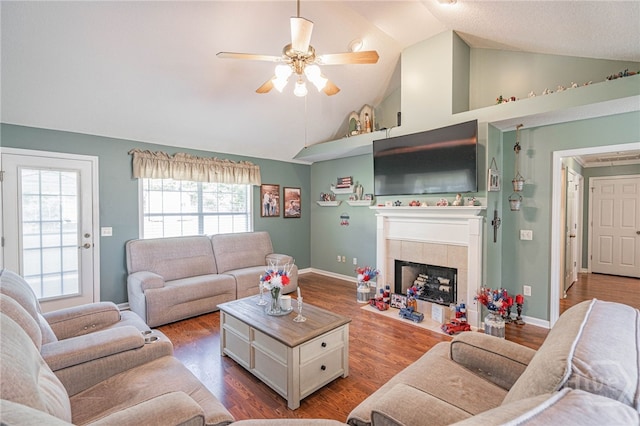 124 Jennifer Cir, Rincon, GA 31326 - living room featuring a ceiling fan, a tiled fireplace, wood finished floors, and high vaulted ceiling