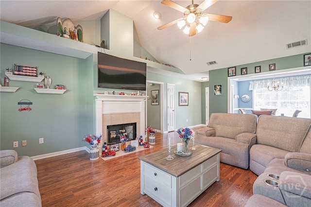 124 Jennifer Cir, Rincon, GA 31326 - living area featuring ceiling fan, dark wood-style flooring, a tiled fireplace, a chandelier, and high vaulted ceiling